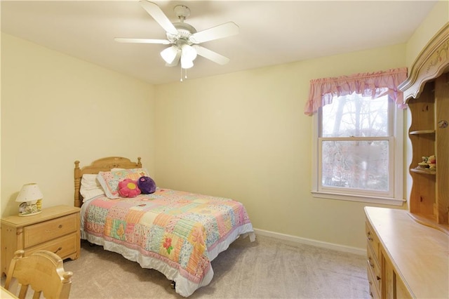 bedroom featuring baseboards, light carpet, and ceiling fan