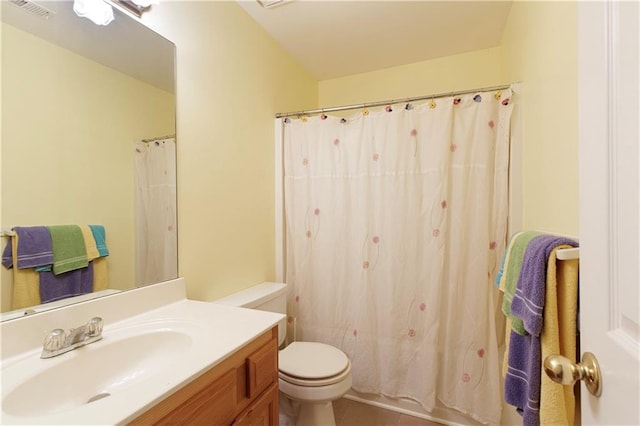 bathroom with vanity, toilet, a shower with curtain, and visible vents