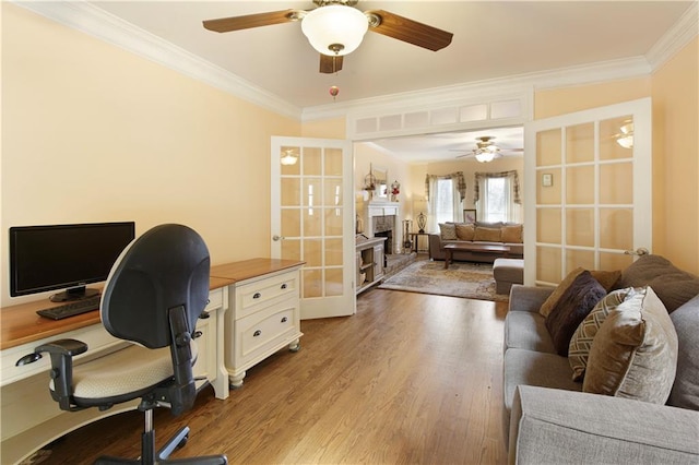 office space featuring ceiling fan, wood finished floors, french doors, and ornamental molding