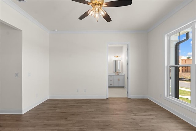 unfurnished room with ceiling fan, crown molding, baseboards, and wood finished floors