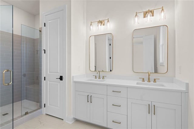 bathroom with marble finish floor, double vanity, a stall shower, and a sink