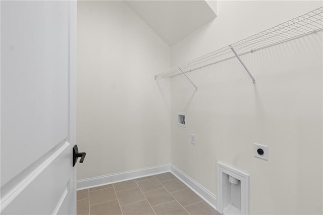 laundry area with washer hookup, electric dryer hookup, tile patterned flooring, laundry area, and baseboards