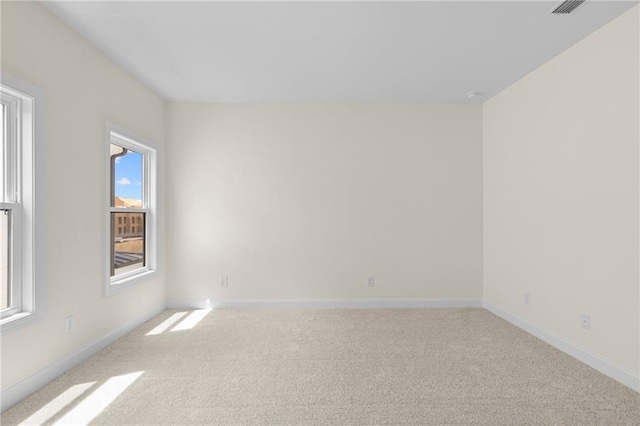 empty room with light carpet and baseboards