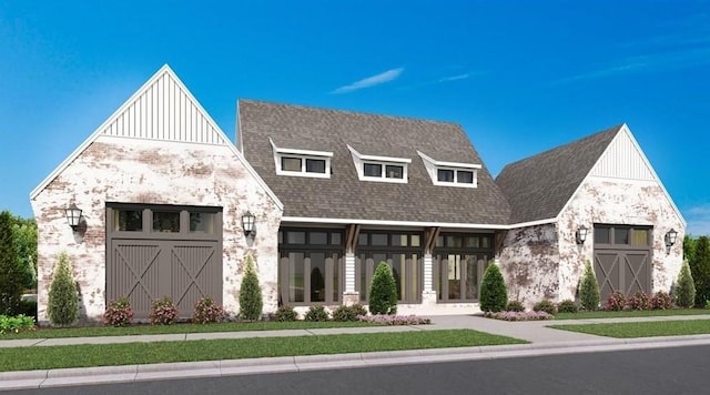 view of front of house featuring board and batten siding, an outbuilding, stone siding, and a shingled roof