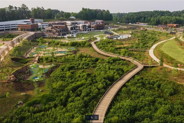 drone / aerial view featuring a wooded view