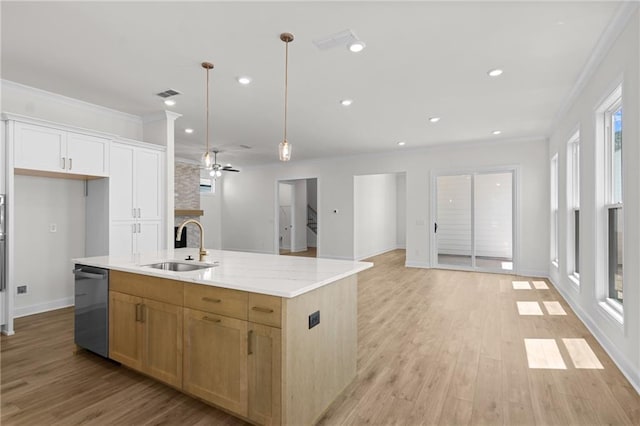 kitchen with light wood-style flooring, a sink, open floor plan, dishwasher, and crown molding