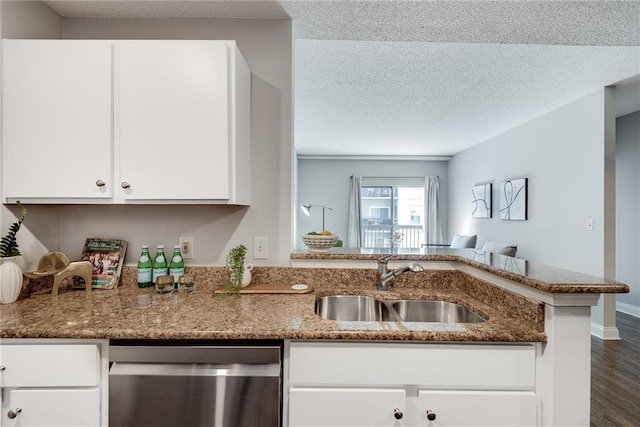 kitchen with a sink, stainless steel dishwasher, a textured ceiling, white cabinetry, and light stone countertops