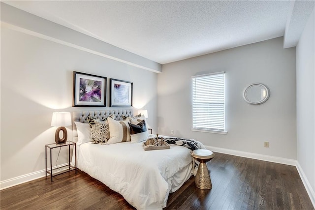 bedroom featuring a textured ceiling, baseboards, and dark wood-style flooring