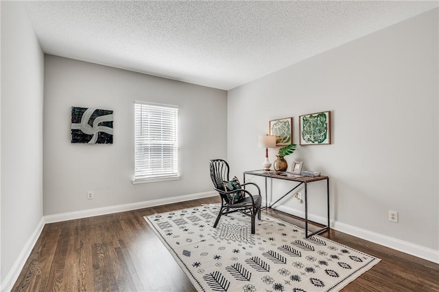 office space with baseboards, a textured ceiling, and wood finished floors