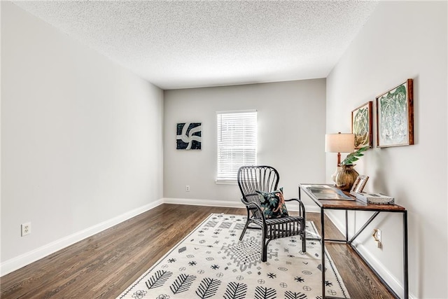 office space with wood finished floors, baseboards, and a textured ceiling