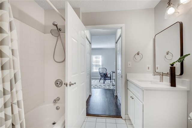 full bathroom featuring vanity, shower / bathtub combination with curtain, tile patterned flooring, and a textured ceiling