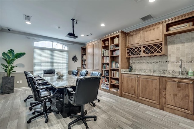 office space featuring crown molding, visible vents, and a sink