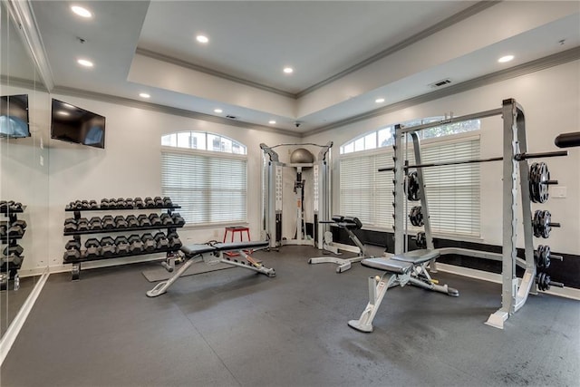 gym featuring recessed lighting, baseboards, a raised ceiling, and crown molding