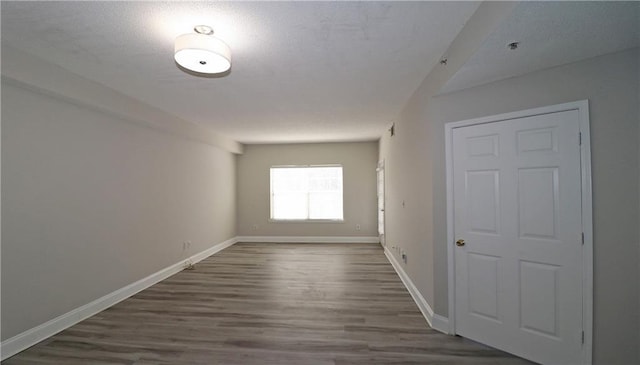 1074 Peachtree Walk NE Unit B 216, Atlanta, GA 30309 - spare room with baseboards, dark wood-style flooring, and a textured ceiling