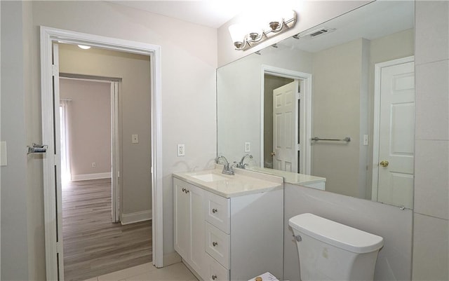 1074 Peachtree Walk NE Unit B 216, Atlanta, GA 30309 - half bathroom featuring vanity, wood finished floors, visible vents, baseboards, and toilet