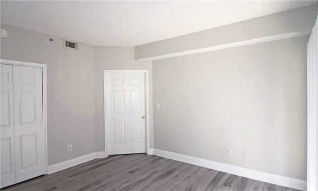 1074 Peachtree Walk NE Unit B 216, Atlanta, GA 30309 - unfurnished bedroom with wood finished floors, visible vents, and baseboards