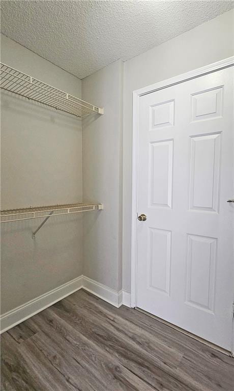 1074 Peachtree Walk NE Unit B 216, Atlanta, GA 30309 - walk in closet featuring dark wood-style flooring
