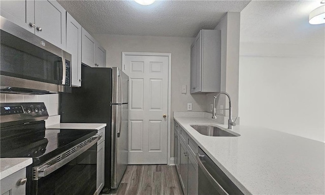 1074 Peachtree Walk NE Unit B 216, Atlanta, GA 30309 - kitchen with backsplash, gray cabinetry, dark wood-type flooring, appliances with stainless steel finishes, and a sink