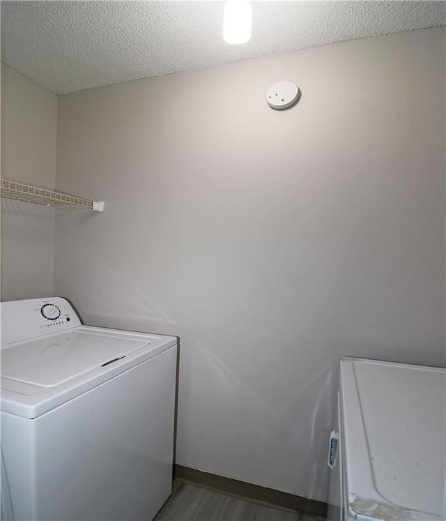 1074 Peachtree Walk NE Unit B 216, Atlanta, GA 30309 - clothes washing area with laundry area, a textured ceiling, washer / clothes dryer, and wood finished floors
