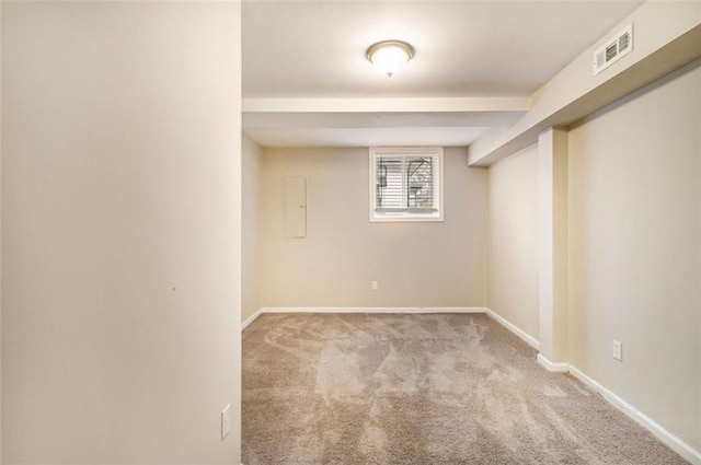 basement featuring light colored carpet