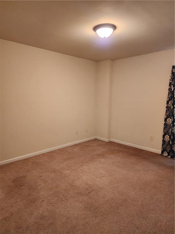 spare room featuring carpet flooring