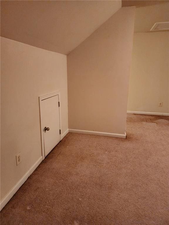 bonus room featuring vaulted ceiling and carpet floors