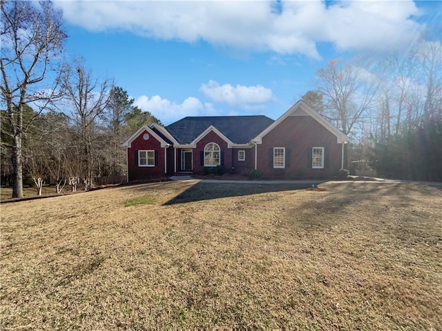 single story home featuring brick siding and a front yard