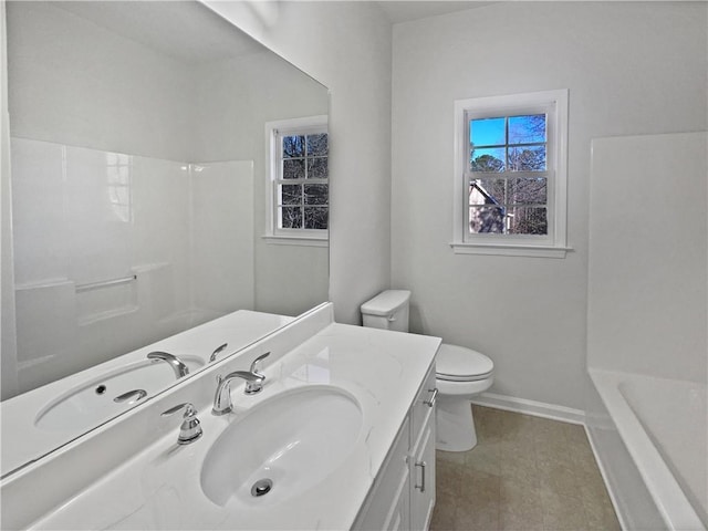 bathroom featuring a shower, toilet, vanity, baseboards, and a bath