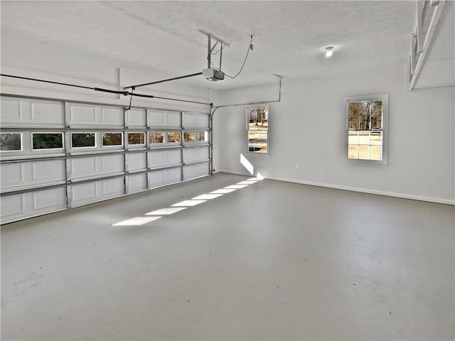 garage featuring a garage door opener and baseboards