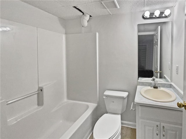 bathroom with a paneled ceiling, toilet, visible vents, vanity, and washtub / shower combination