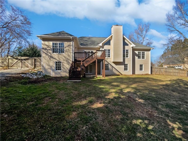 rear view of house with a fenced backyard, stairway, a lawn, a gate, and a chimney