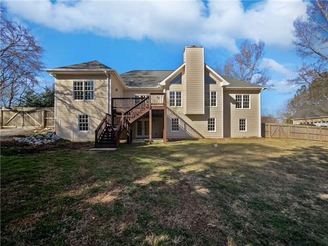 rear view of property with a fenced backyard, a chimney, stairway, a gate, and a yard