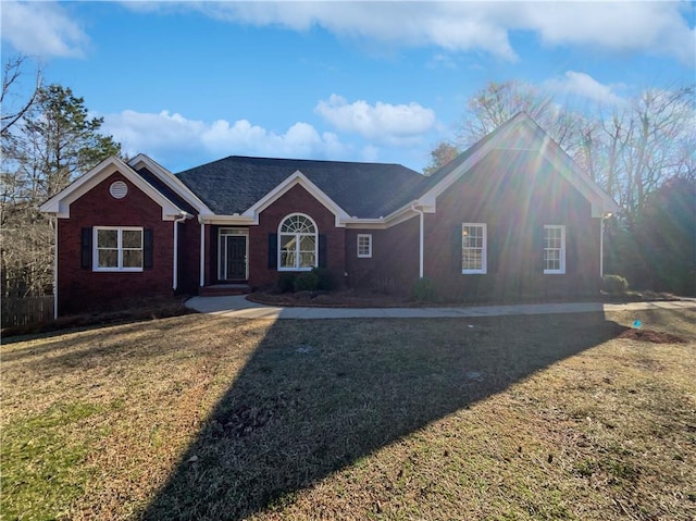 ranch-style house with brick siding and a front yard