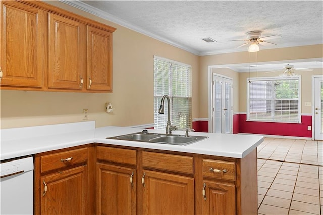 2881 Bridle Creek Dr SW, Conyers, GA 30094 - kitchen with a sink, dishwasher, a peninsula, ceiling fan, and brown cabinetry