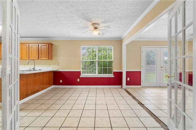 2881 Bridle Creek Dr SW, Conyers, GA 30094 - kitchen with french doors, ceiling fan, light countertops, baseboards, and brown cabinetry