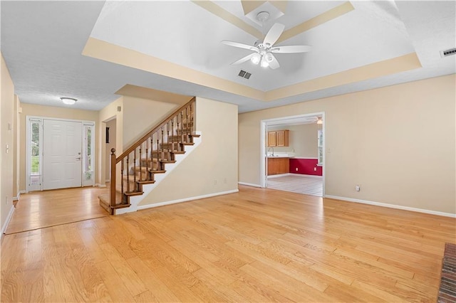 2881 Bridle Creek Dr SW, Conyers, GA 30094 - entryway with a tray ceiling, baseboards, stairway, a ceiling fan, and light wood finished floors