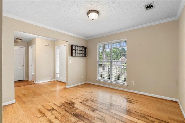 2881 Bridle Creek Dr SW, Conyers, GA 30094 - empty room featuring light wood-type flooring, a textured ceiling, baseboards, and ornamental molding