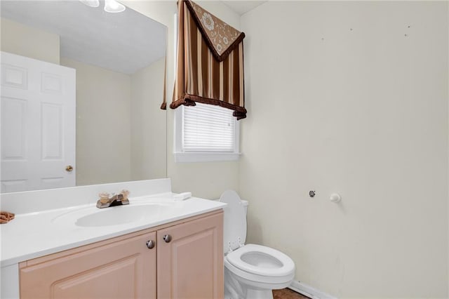 half bathroom with vanity and toilet