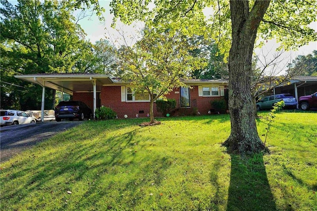 ranch-style home featuring a front yard and a carport