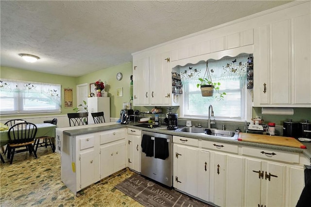 kitchen with a textured ceiling, sink, white cabinets, and dishwasher