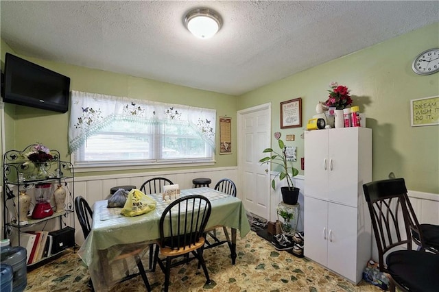 dining room featuring a textured ceiling