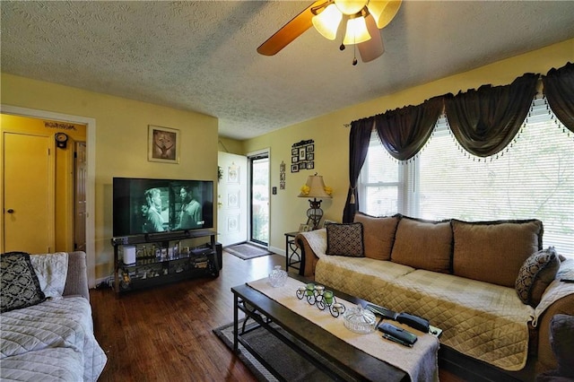 living room featuring a textured ceiling, ceiling fan, and dark hardwood / wood-style flooring