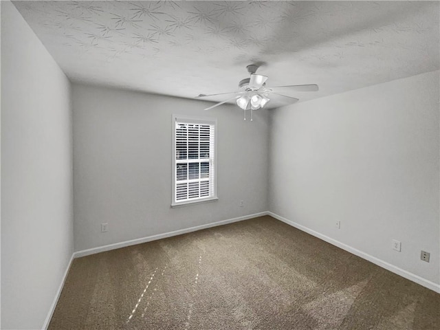 carpeted empty room featuring a textured ceiling and ceiling fan