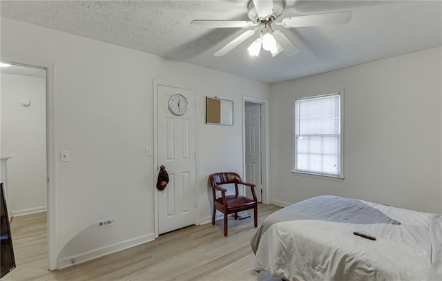 bedroom with light wood-type flooring and ceiling fan