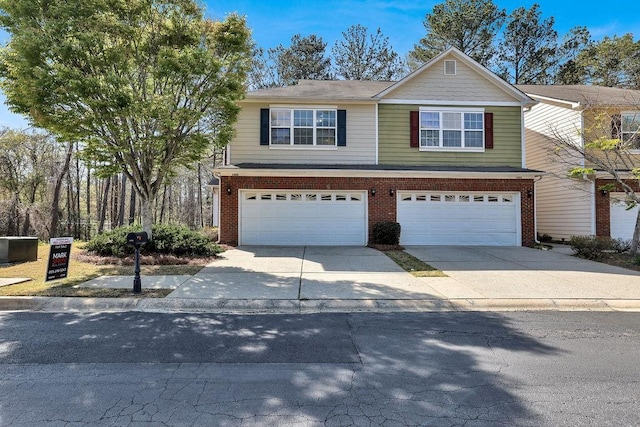 view of front facade featuring an attached garage, concrete driveway, and brick siding