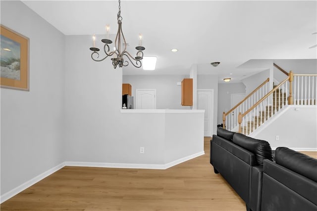 living room with a chandelier, light wood-type flooring, baseboards, stairway, and recessed lighting