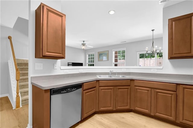 kitchen with stainless steel dishwasher, light wood finished floors, brown cabinetry, a ceiling fan, and a sink