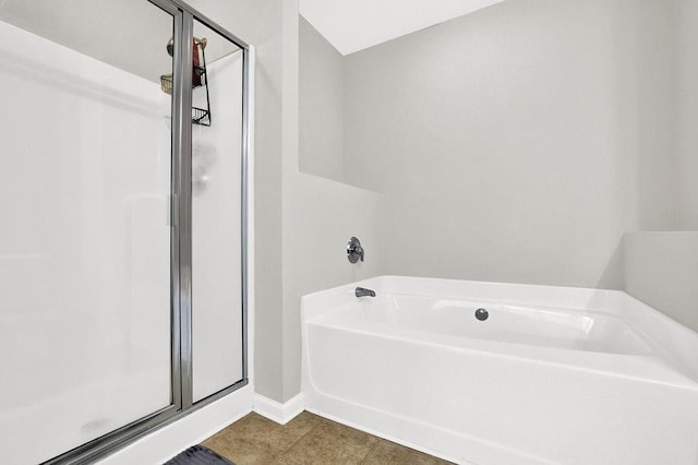 full bathroom with a stall shower, a bath, baseboards, and tile patterned floors