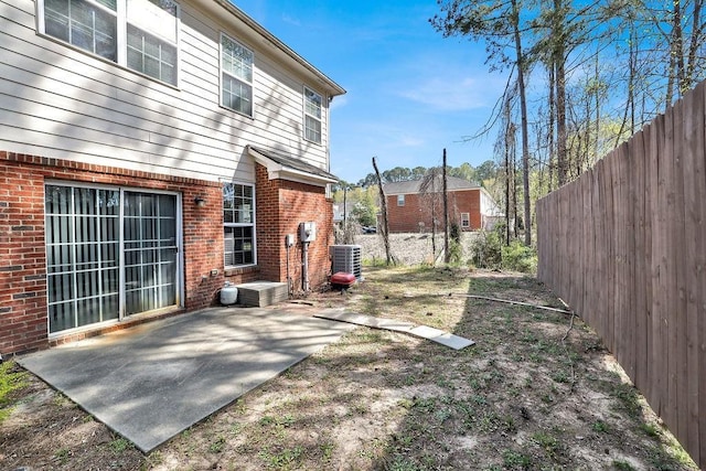 back of property with a patio area, central AC, fence, and brick siding