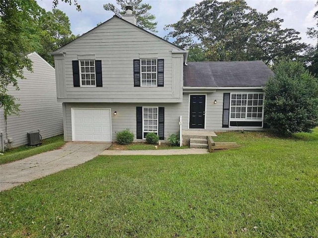 tri-level home featuring a garage and a front lawn